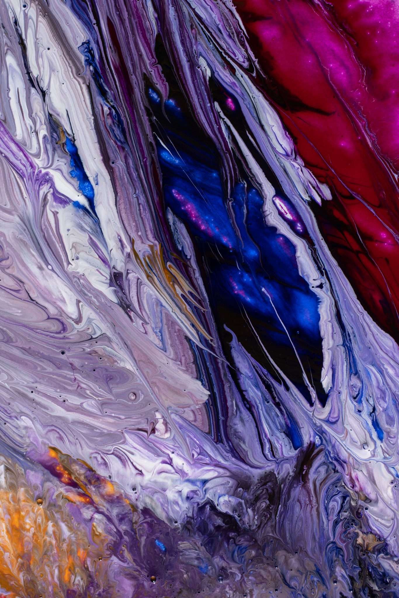 Beautiful abstraction of liquid paints in slow blending flow mixing together gently