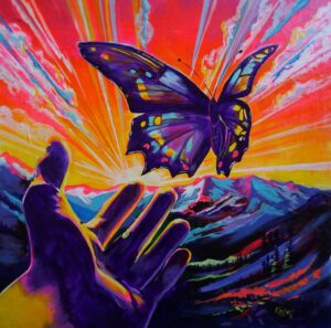 Acrylic painting by Karen DeFrates of a butterfly being let go by a hand to a vibrant mountain