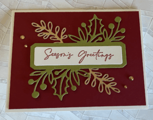 Holiday card made TriArts class with words "Seasons Greetings" and gold accents.