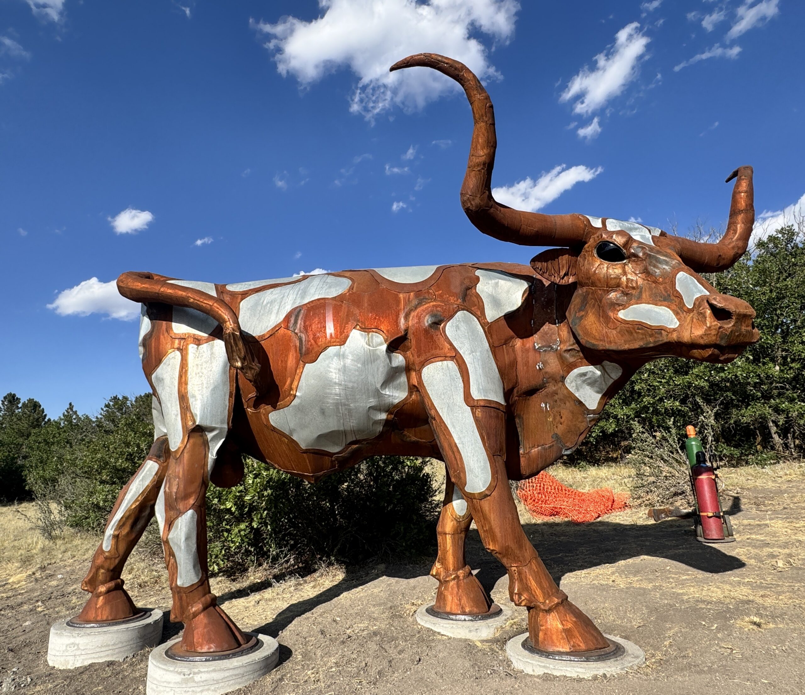 Photo of castle rock public art sculpture of 3 large steel cattle titled big drive
