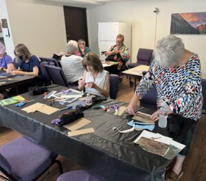 Outreach program class photos of people painting