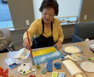 Outreach program class photos of people painting