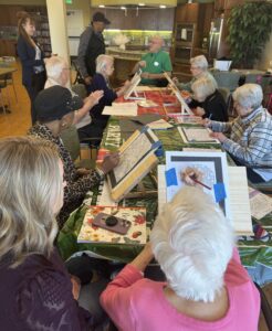Outreach program class photos of people painting