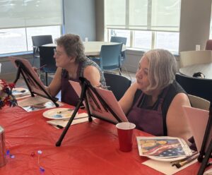 Outreach program class photos of people painting