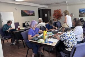 Outreach program class photos of people painting