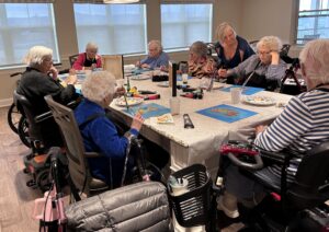 Outreach program class photos of people painting