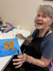 Outreach program class photos of people painting