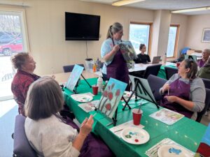 Outreach program class photos of people painting