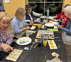 Outreach program class photos of people painting