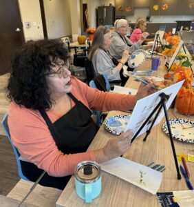 Outreach program class photos of people painting